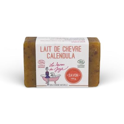 Savon LAIT DE CHÈVRE CALENDULA de la marque Les Savons de Joya, affichant des certifications COSMOS ORGANIQUE et BIO. Le savon présente une couleur marron avec des pétales, indiquant sa composition naturelle et ses propriétés apaisantes, et pèse 100g.