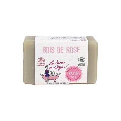 Savon artisanal parfumé au BOIS DE ROSE de la marque 'Les Savons de Joya', affichant des certifications 'COSMOS ORGANIC' et 'BIO'. Le savon est de couleur uniforme, pèse 100g, et est noté comme étant 100% d'origine naturelle.